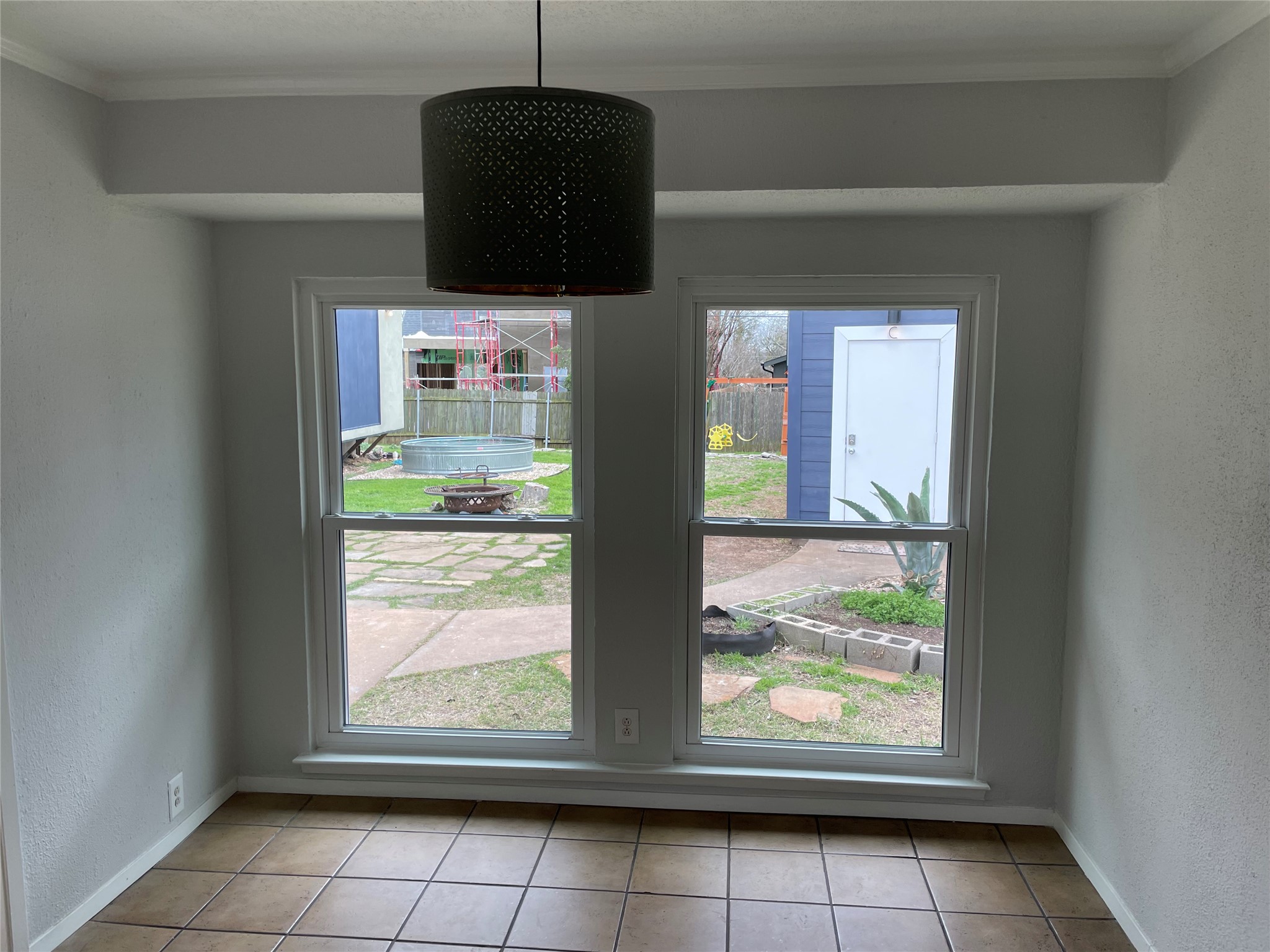 4619 Jinx Avenue, Unit A Austin, TX 78745 - Photo 6 of 21 Tiled flooring with contrasting grout, recessed lighting, and a contemporary perforated metal pendant light fixture