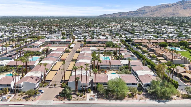 an aerial view of residential houses with city view