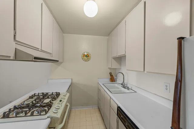 a kitchen with a sink and refrigerator