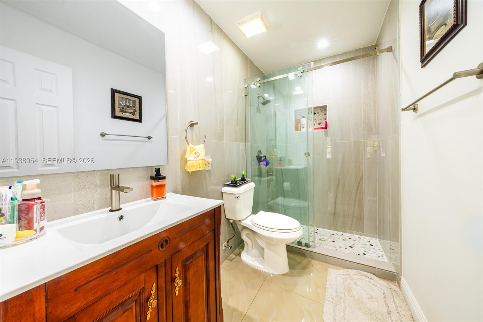 1937 Southwest 57th Court Miami, FL 33155 - Photo 13 of 23 a bathroom with a sink toilet a mirror and shower