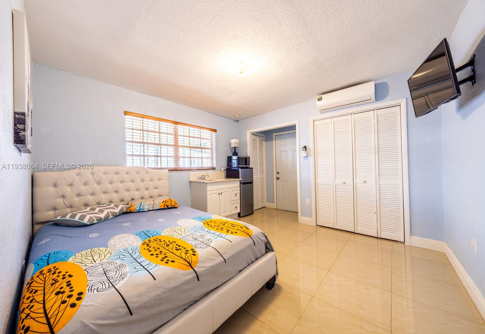1937 Southwest 57th Court Miami, FL 33155 - Photo 15 of 23 a spacious bedroom with a bed and a couch