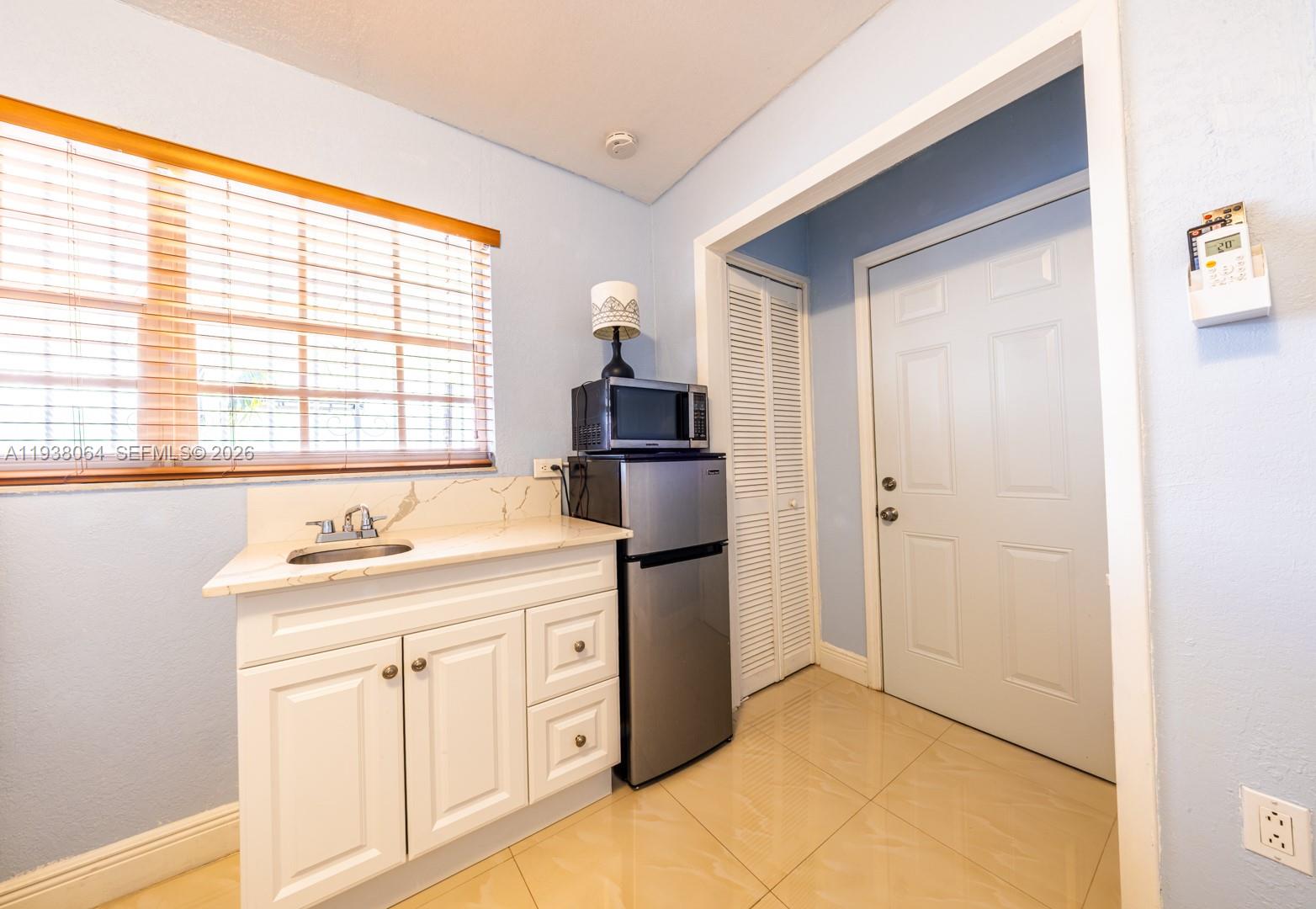 1937 Southwest 57th Court Miami, FL 33155 - Photo 16 of 23 a kitchen with stainless steel appliances granite countertop a refrigerator and a sink