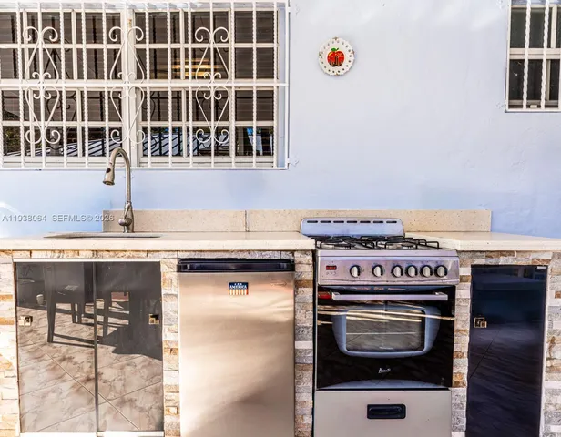 a kitchen with a stove and a sink