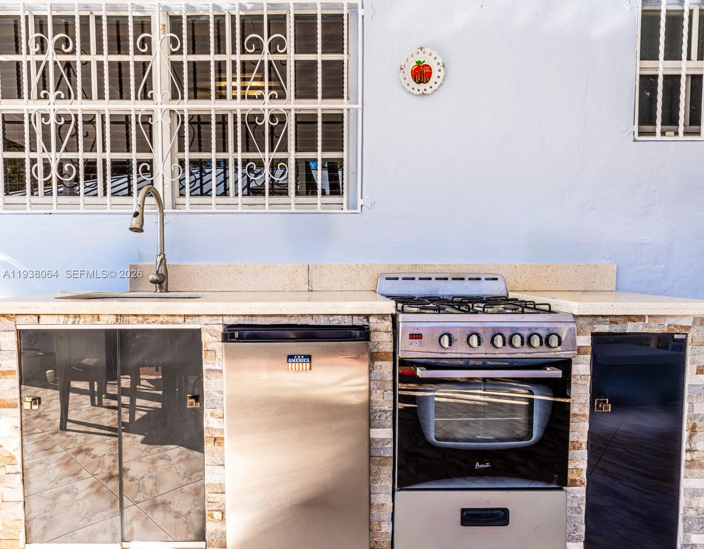 1937 Southwest 57th Court Miami, FL 33155 - Photo 20 of 23 a kitchen with a stove and a sink
