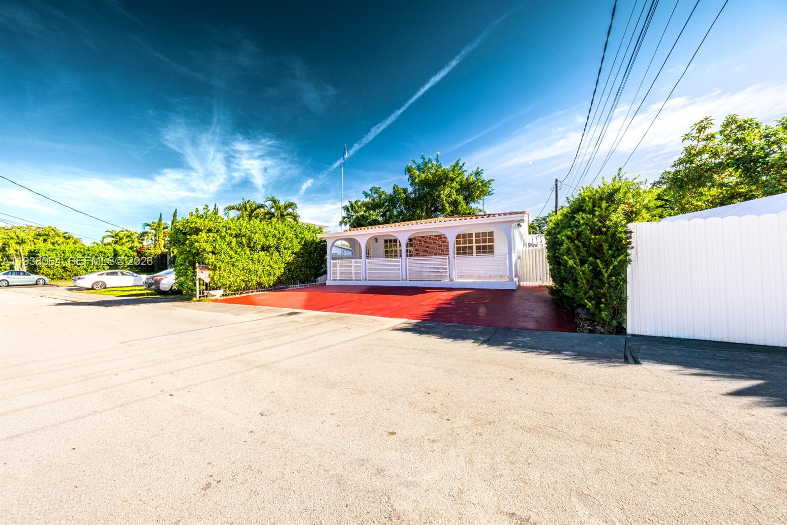 1937 Southwest 57th Court Miami, FL 33155 - Photo 2 of 23 a view of a house with a yard and potted plants
