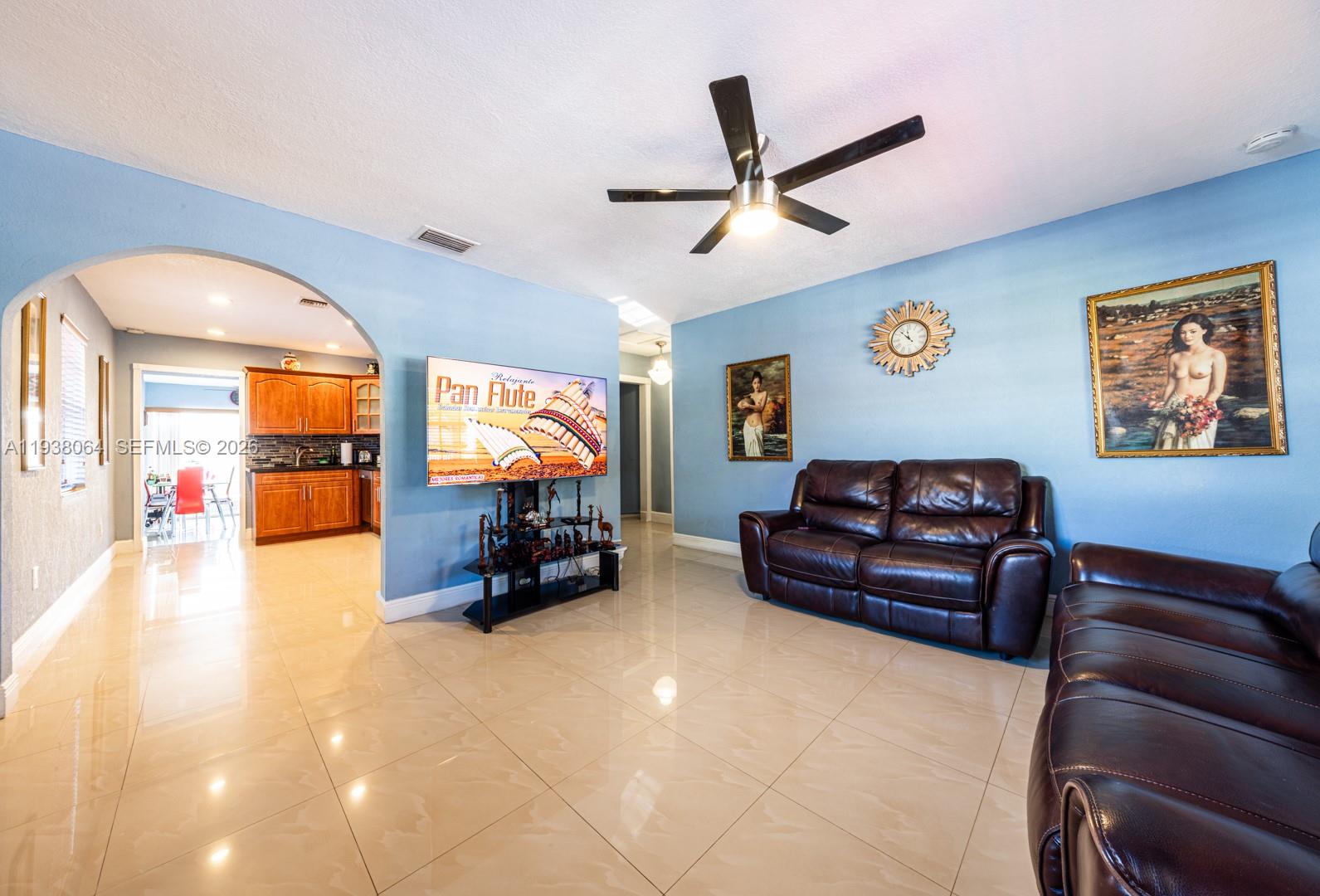 1937 Southwest 57th Court Miami, FL 33155 - Photo 7 of 23 a living room with furniture and a flat screen tv with painted walls