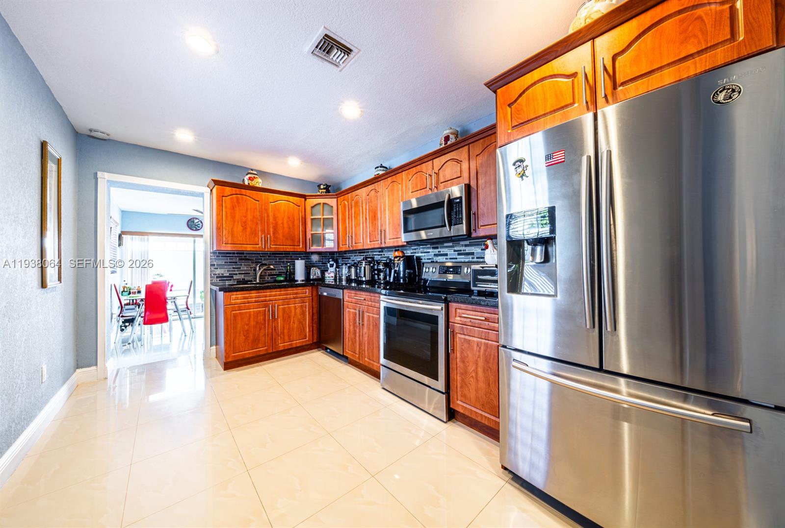 1937 Southwest 57th Court Miami, FL 33155 - Photo 8 of 23 a kitchen with stainless steel appliances granite countertop a refrigerator and a sink