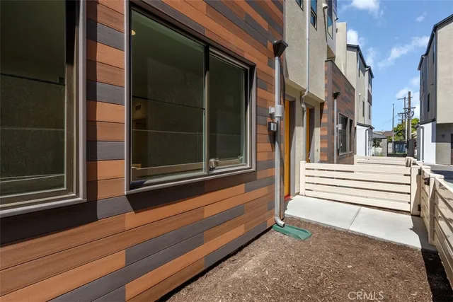 a view of a door of the house with a bench