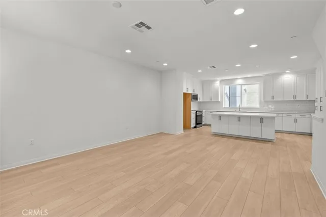 a view of kitchen with wooden floor and large windows