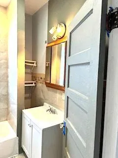 a bathroom with a sink a toilet and a mirror