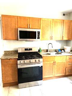 3100 West Lexington Street Chicago, IL 60612 - Photo 9 of 11 a kitchen with a stove and a microwave