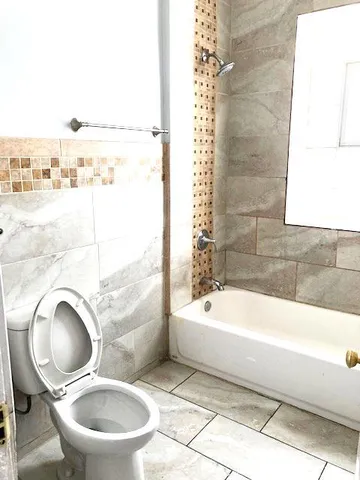 a bathroom with a bathtub and a toilet