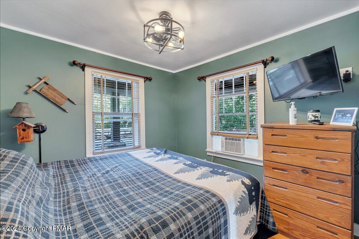 190 Knob Road Mount Pocono, PA 18344 - Photo 36 of 37 a bedroom with a bed and a chandelier