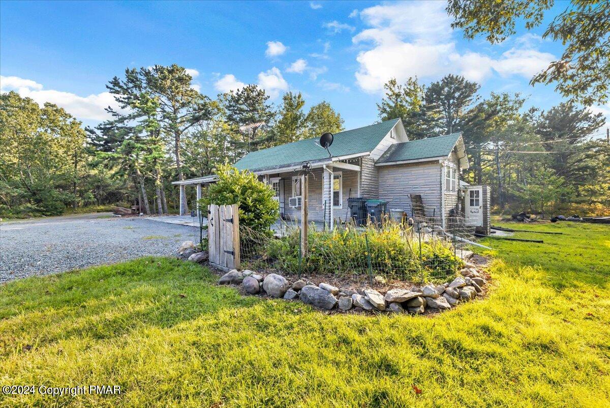 190 Knob Road Mount Pocono, PA 18344 - Photo 5 of 37 a view of a house with a small yard plants and large tree