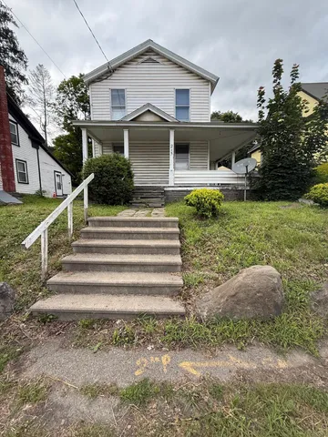 a front view of a house with a yard