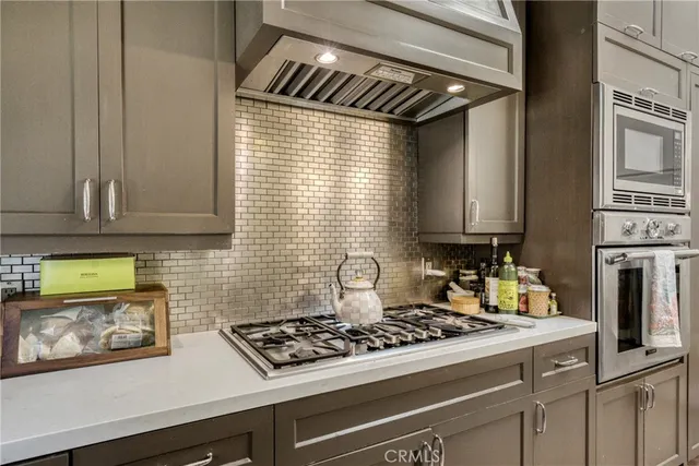 a stove top oven sitting inside of a kitchen