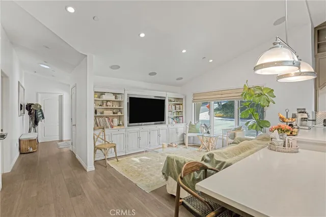a view of a livingroom with furniture window and wooden floor