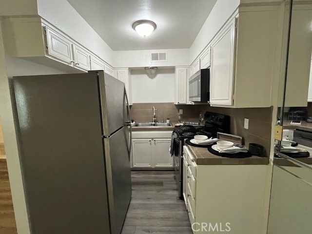a kitchen with a refrigerator stove and sink