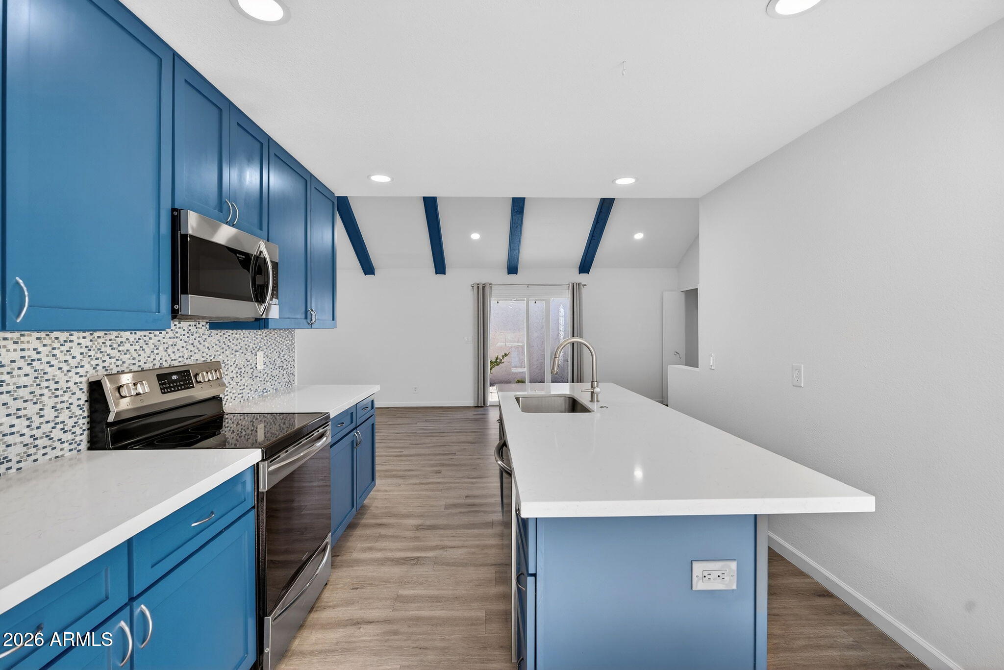 330 East Embassy Street Tempe, AZ 85288 - Photo 14 of 68 a kitchen with stainless steel appliances a sink a stove a refrigerator cabinets and a counter top space