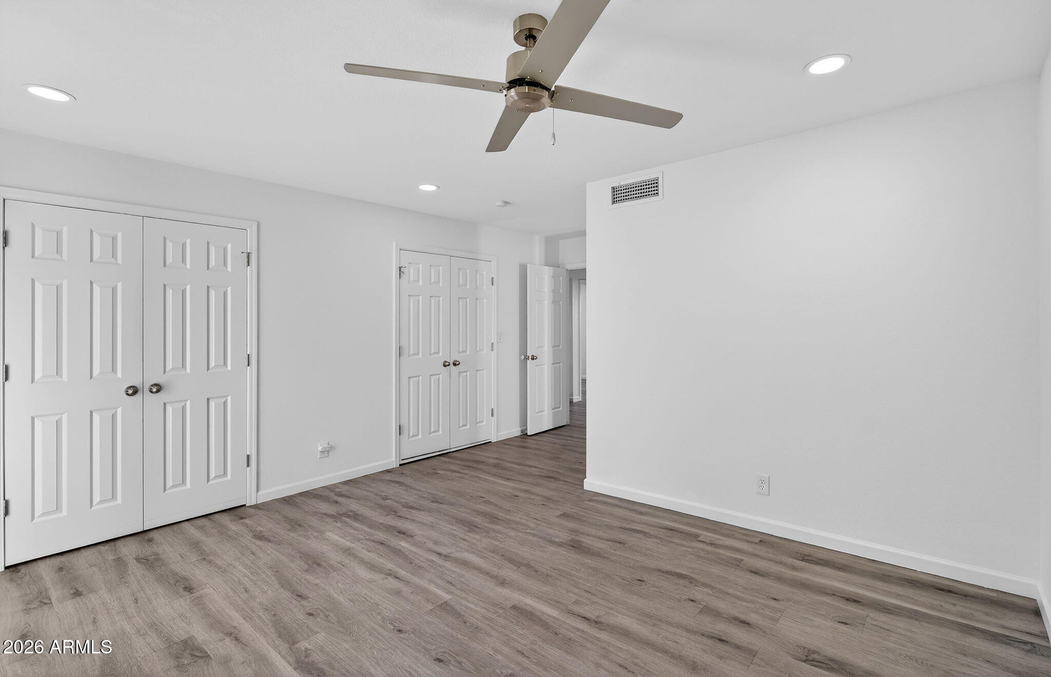 330 East Embassy Street Tempe, AZ 85288 - Photo 21 of 68 wooden floor in an empty room with a ceiling fan