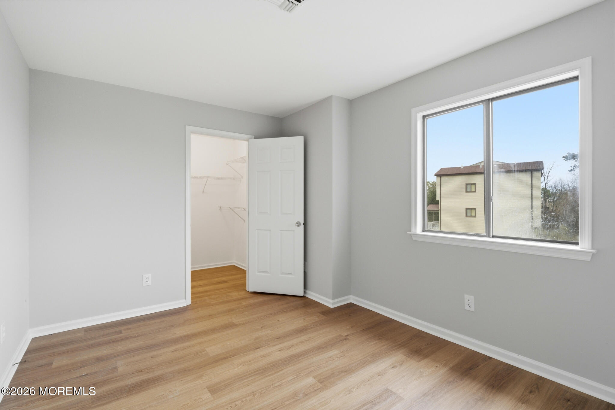 1606 Alpine Trail Neptune Township, NJ 07753 - Photo 16 of 33 a view of an empty room with wooden floor and a window