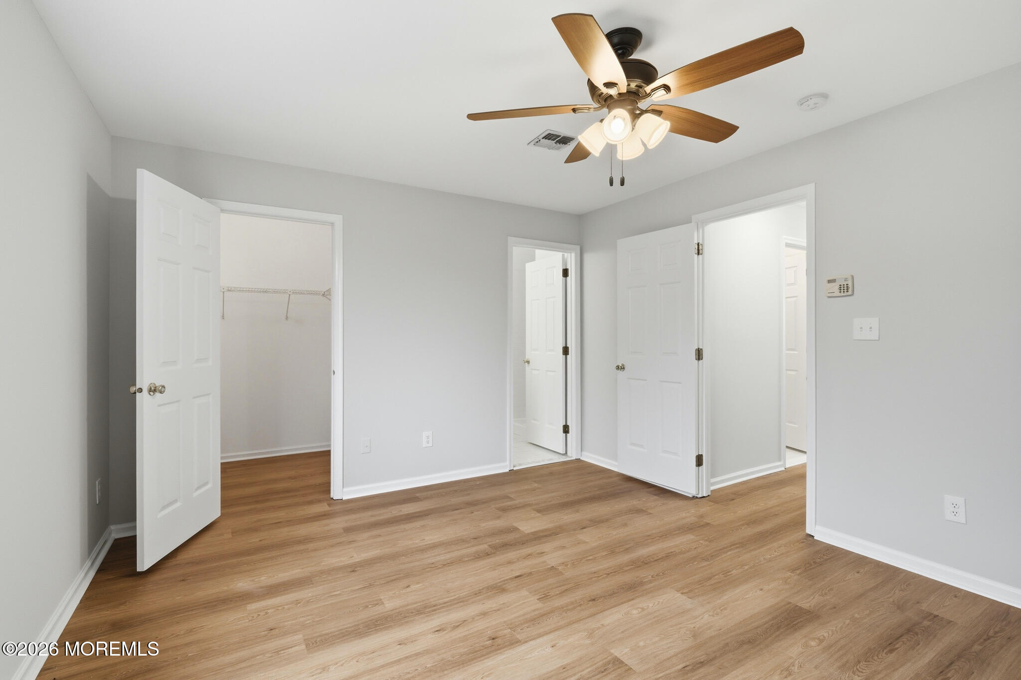 1606 Alpine Trail Neptune Township, NJ 07753 - Photo 21 of 33 an empty room with wooden floor and ceiling fan