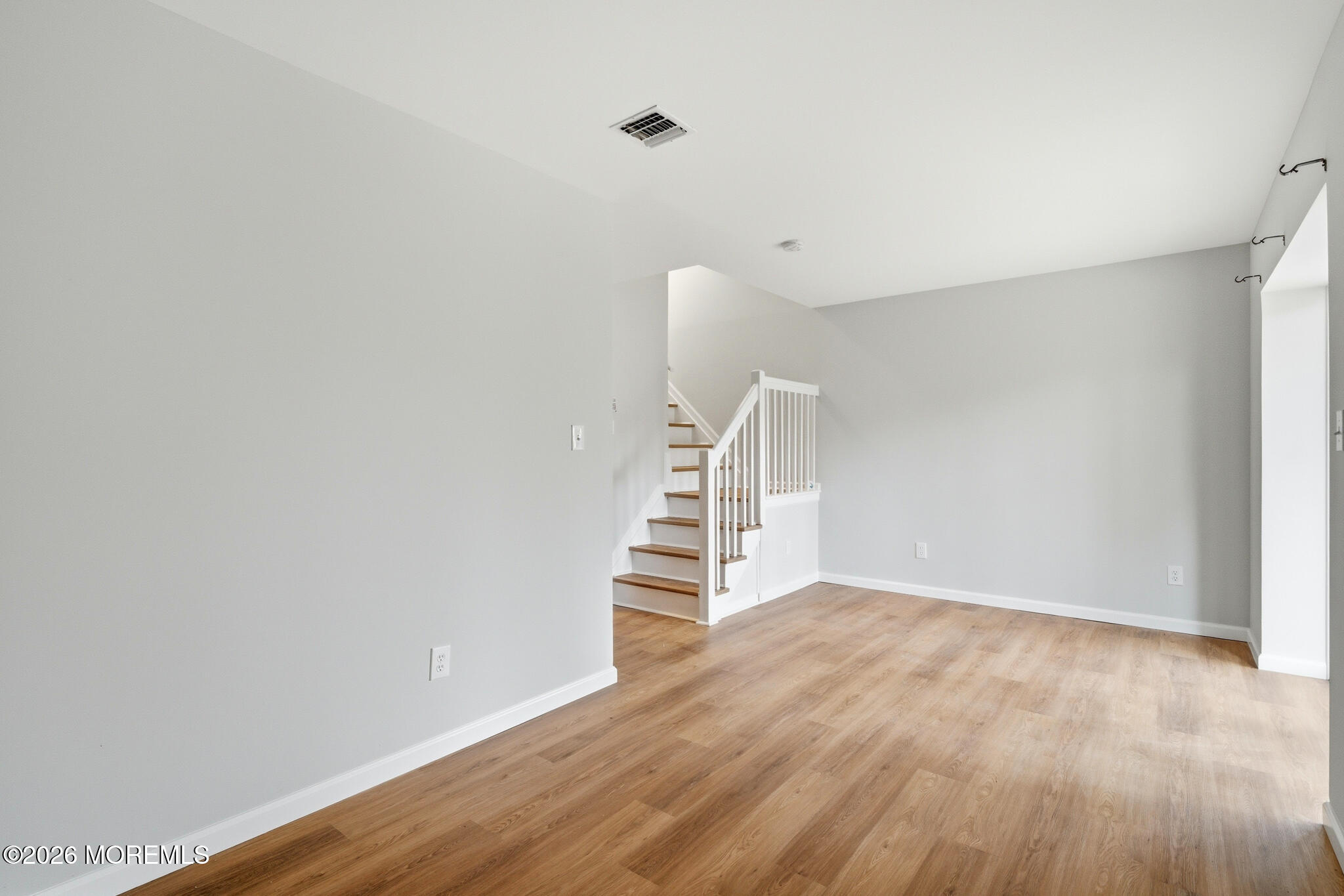 1606 Alpine Trail Neptune Township, NJ 07753 - Photo 24 of 33 a view of room with stairs and wooden floor