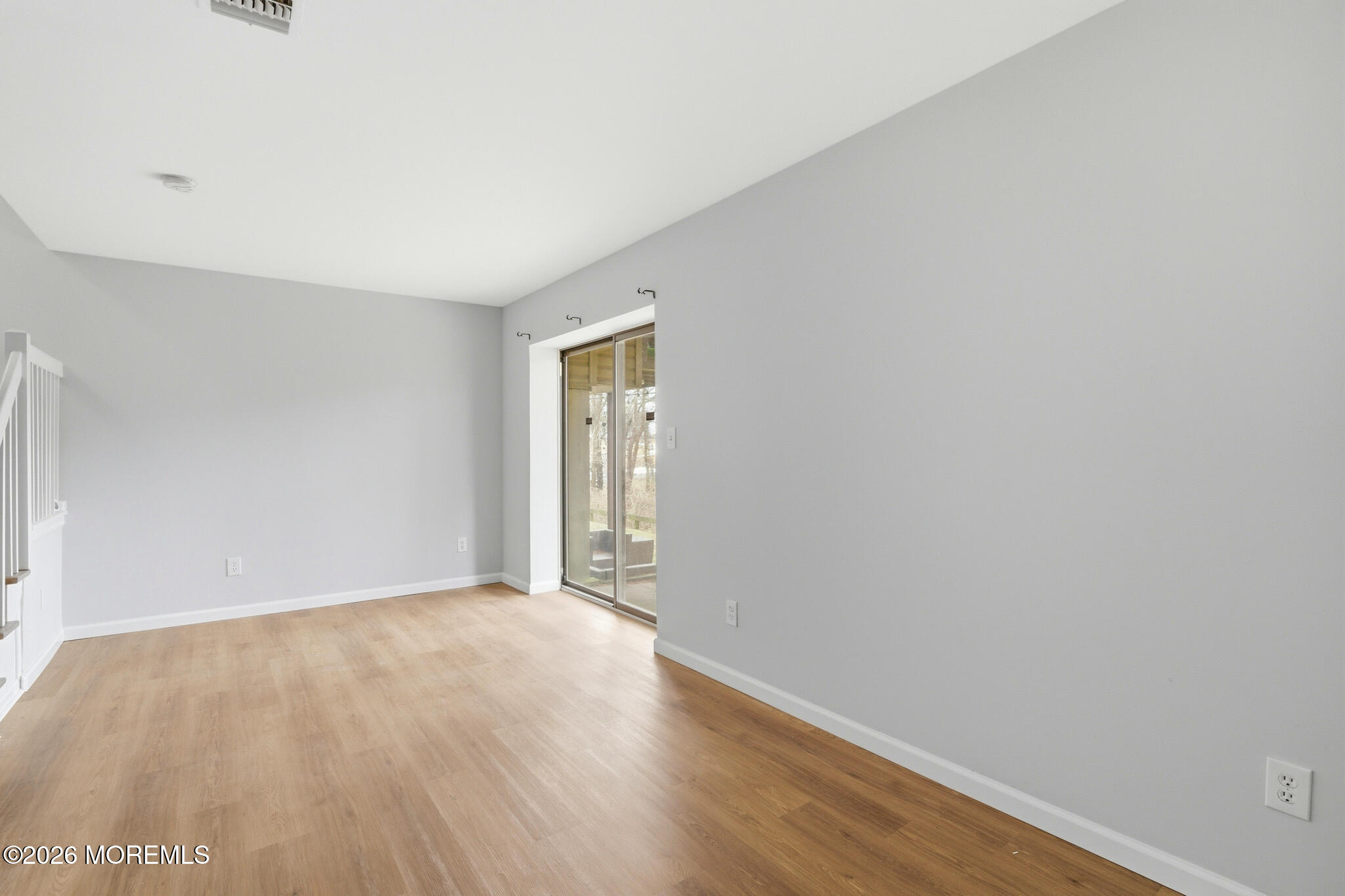 1606 Alpine Trail Neptune Township, NJ 07753 - Photo 27 of 33 a view of an empty room with wooden floor and a window