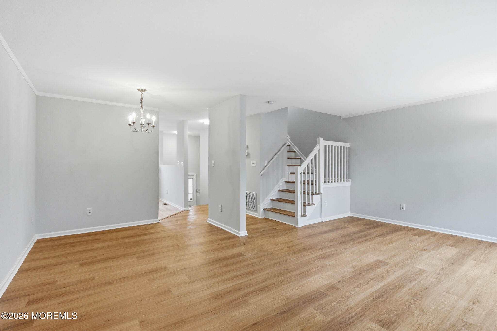 1606 Alpine Trail Neptune Township, NJ 07753 - Photo 6 of 33 an empty room with wooden floor and staircase
