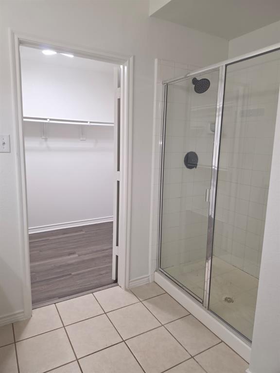 8047 New Kent Road Frisco, TX 75035 - Photo 26 of 27 Shower stall with clear glass enclosure and black fixtures