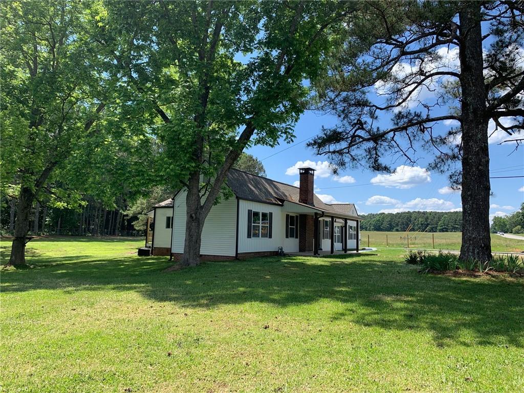 2036 Rockmart Road Villa Rica, GA 30180 - Photo 1 of 1 a front view of house with a garden and trees