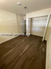 1680 Northwest 4th Avenue, Unit 8B Miami, FL 33136 - Photo 9 of 9 an empty room with wooden floor