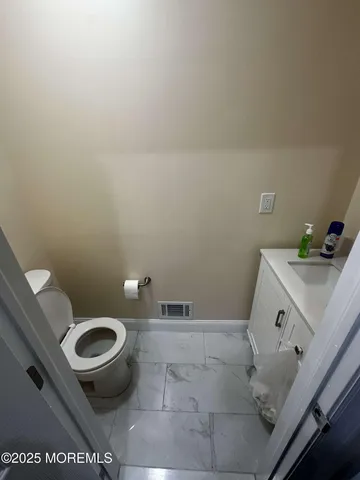 a view of an empty room and wooden floor