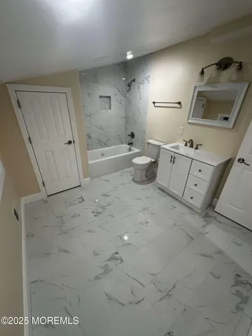 a bathroom with a sink toilet and tub