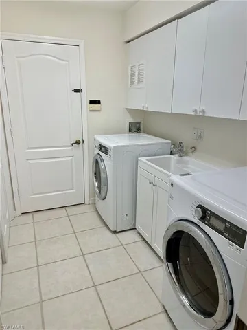a bedroom with a bed and a flat tv screen on dresser