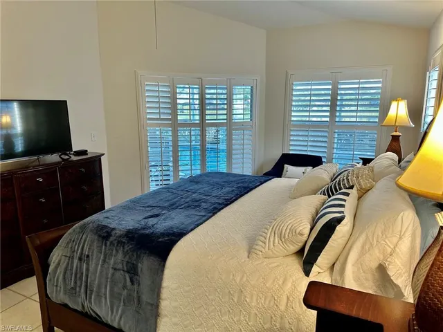 a bathroom with double vanity sink and shower