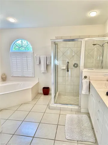 a bathroom with a granite countertop sink a shower and a mirror