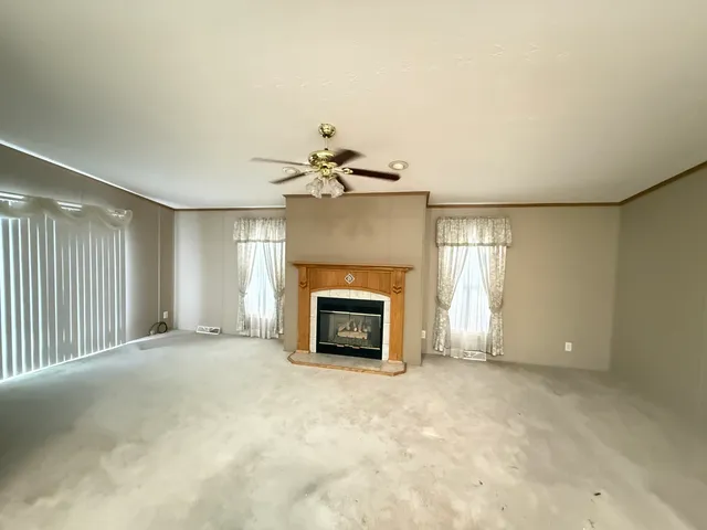 a view of a room with a fireplace and window