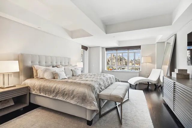 a spacious bedroom with a bed and a couch