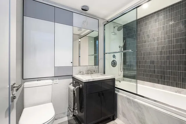a bathroom with a sink toilet and shower