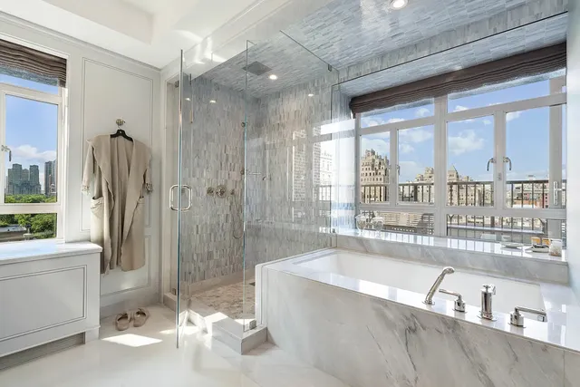 a spacious bathroom with a large tub and shower