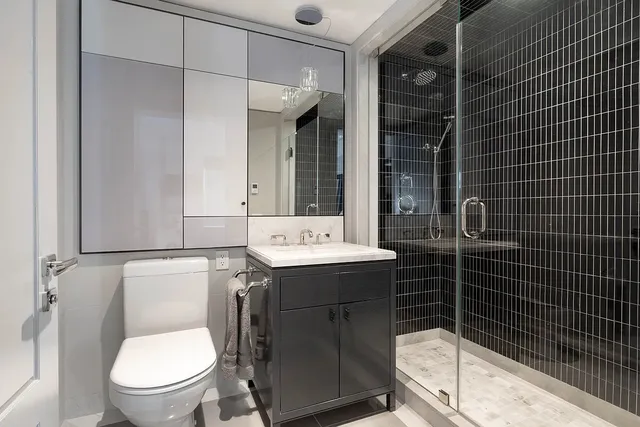 a bathroom with a sink toilet and shower
