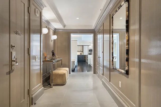 a view of a hallway with a livingroom and furniture