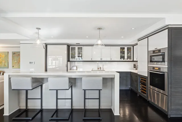 a kitchen with a sink cabinets and stainless steel appliances