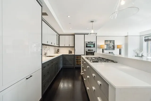 a kitchen with a sink stove and cabinets