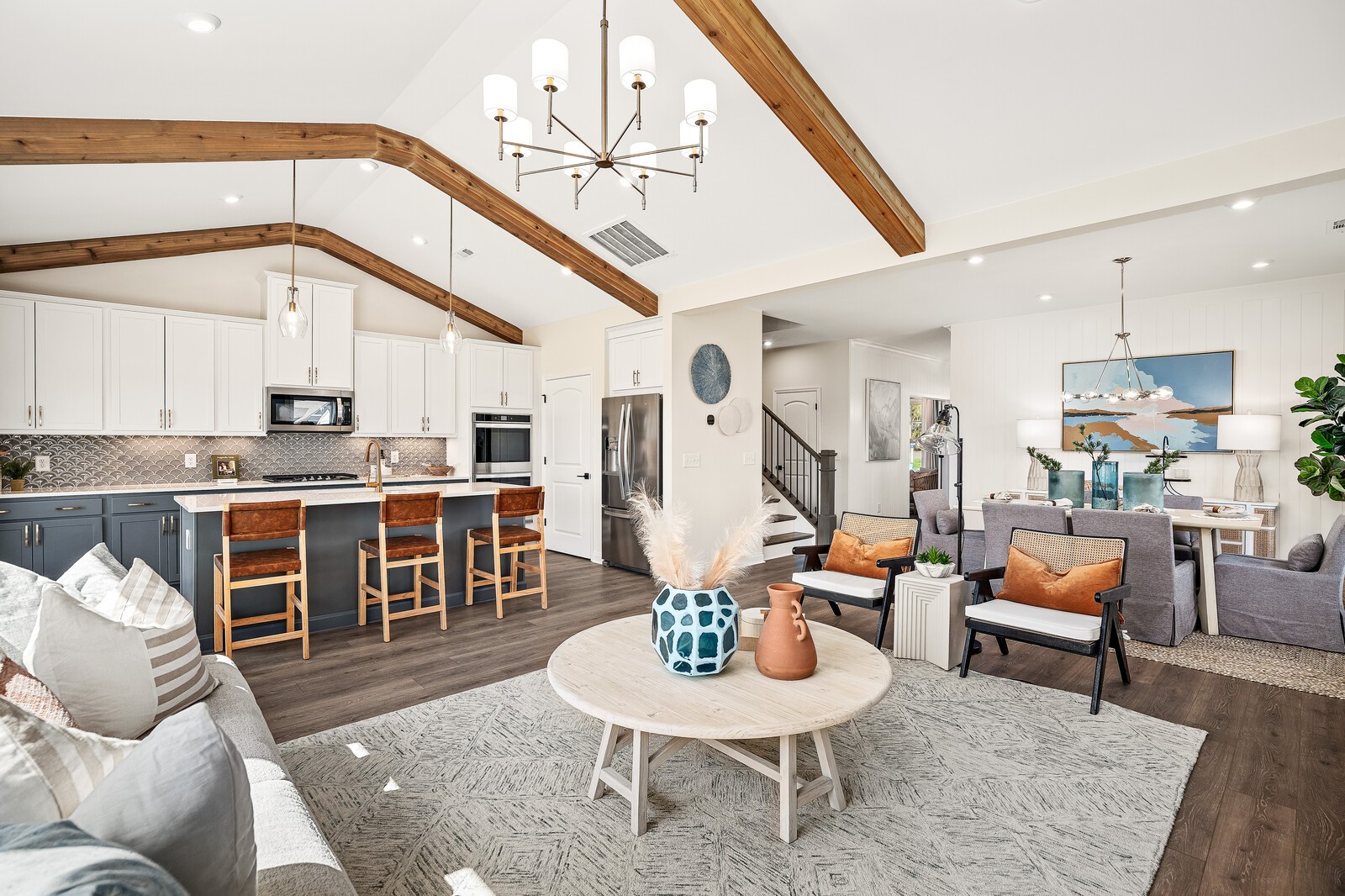 7689 Hatcher Heights Drive Fairview, TN 37062 - Photo 20 of 47 a living room with couches chairs and kitchen view with wooden floor