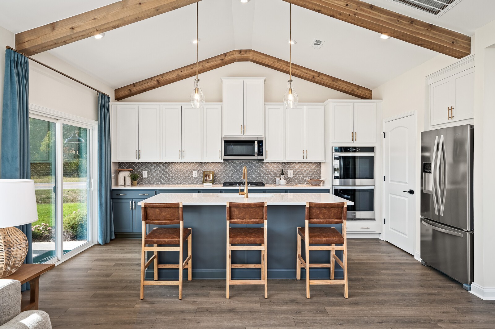 7689 Hatcher Heights Drive Fairview, TN 37062 - Photo 21 of 47 a kitchen with stainless steel appliances granite countertop a stove a refrigerator a kitchen island with a stove and white cabinets