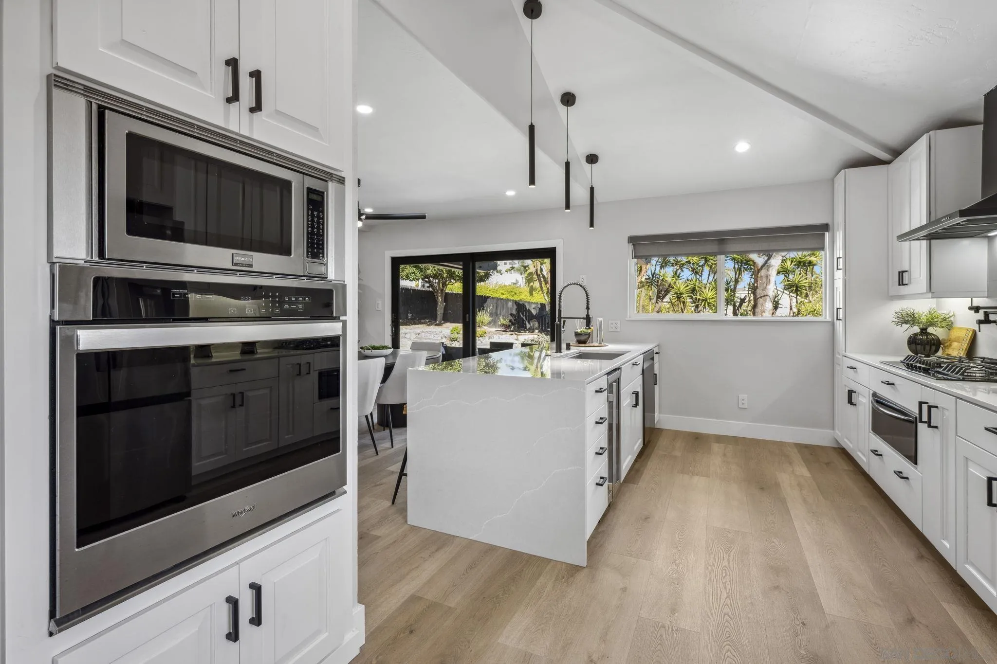 2026 Estero Street Oceanside, CA 92054 - Photo 18 of 72 a kitchen with stainless steel appliances kitchen island granite countertop a stove a sink and a microwave
