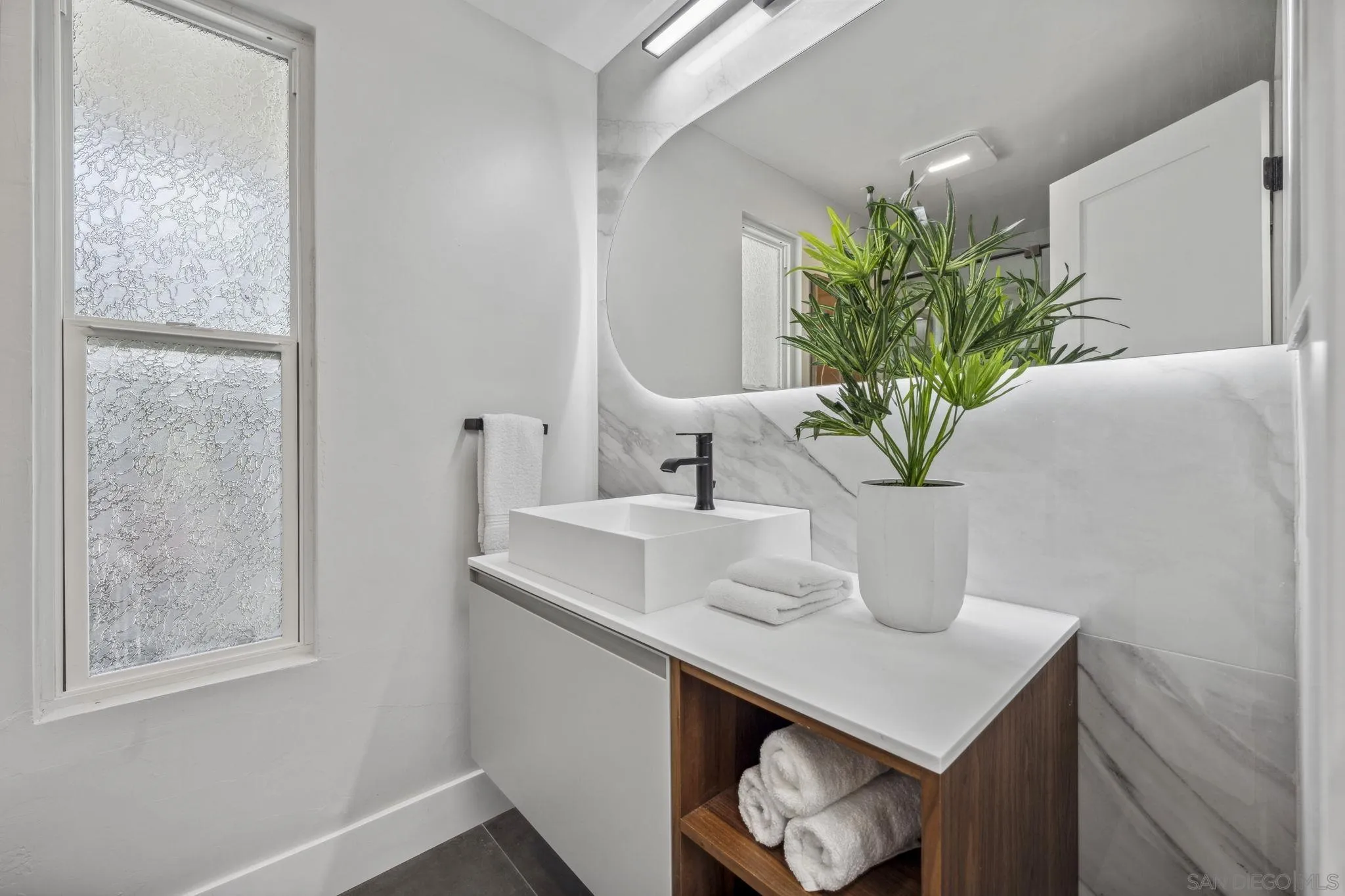 2026 Estero Street Oceanside, CA 92054 - Photo 20 of 72 a close view of light sink and potted plant on the counter