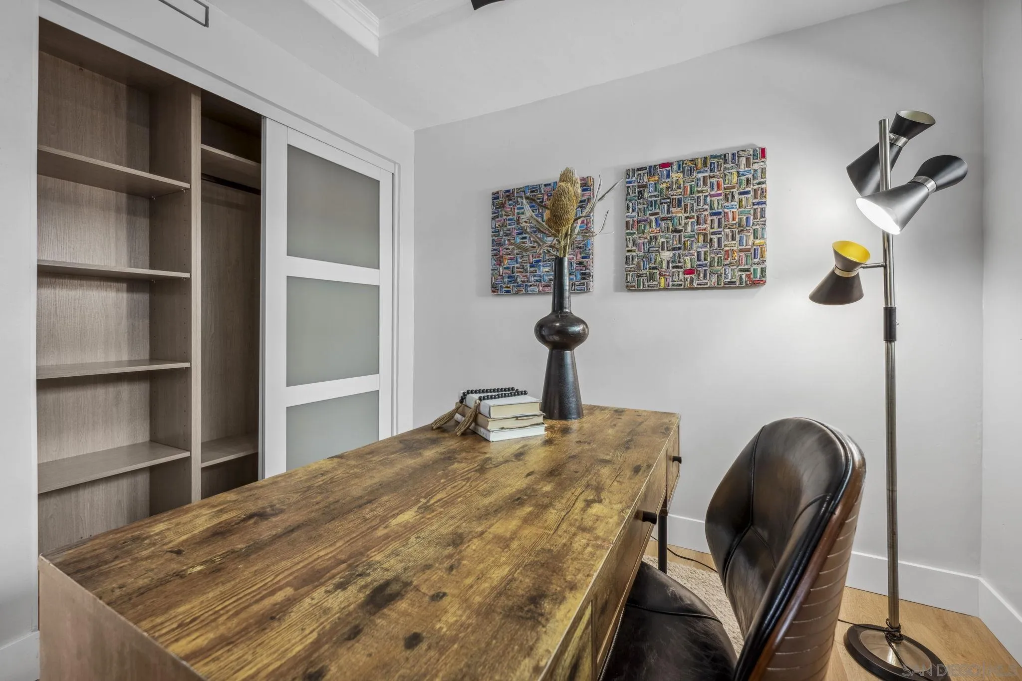 2026 Estero Street Oceanside, CA 92054 - Photo 25 of 72 a bedroom with a bed and a chandelier